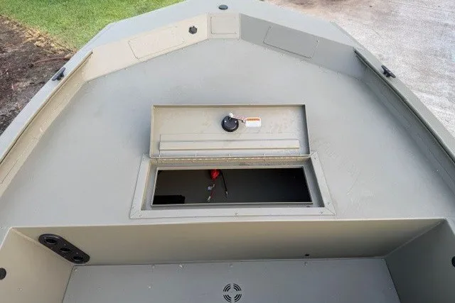 Slide: The Image of 2026 Tracker Grizzly 1754 SC boat interior with storage compartment open. - 6
