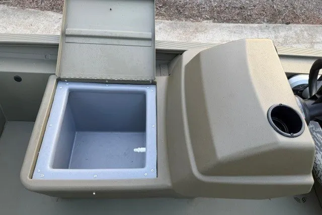 Slide: The Image of 2026 Tracker Grizzly 1754 SC boat interior with open storage compartment and console. - 9
