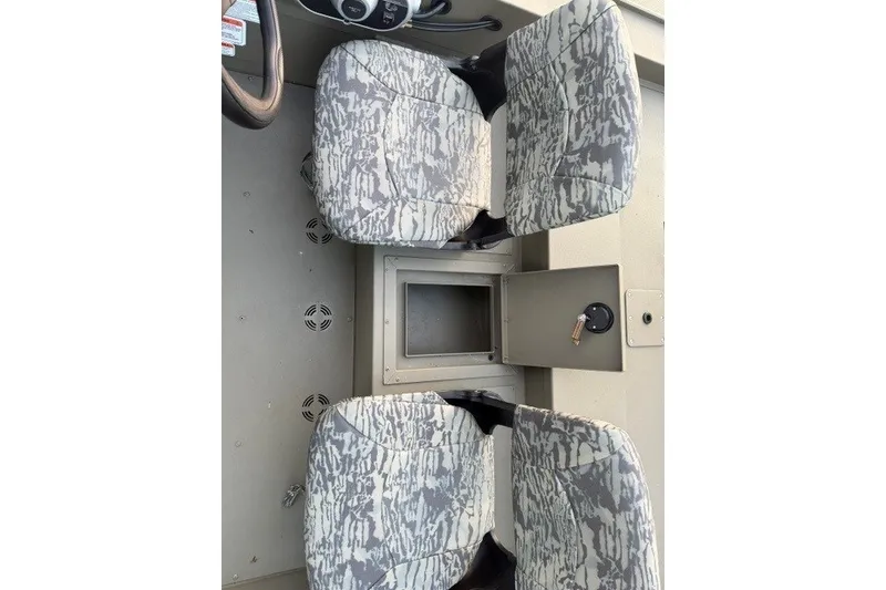 Slide: The Image of Interior of 2026 Tracker Grizzly 1754 SC boat with camo-patterned seats. - 7