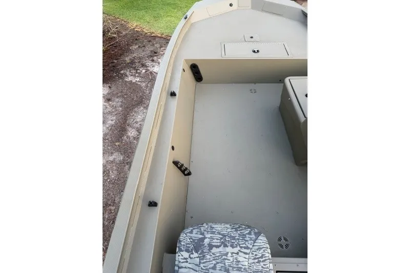 Slide: The Image of 2026 Tracker Grizzly 1754 SC boat interior with seating and storage compartments. - 13