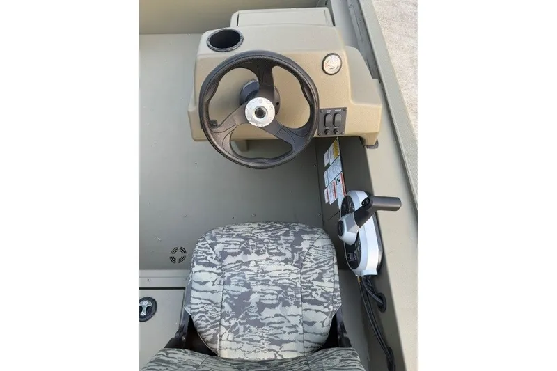 Slide: The Image of Steering console of 2026 Tracker Grizzly 1754 SC boat with camo seat. - 11