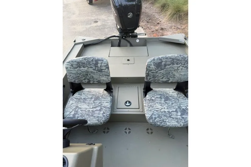 Slide: The Image of 2026 Tracker Grizzly 1754 SC boat interior with camo-patterned seats and motor. - 10