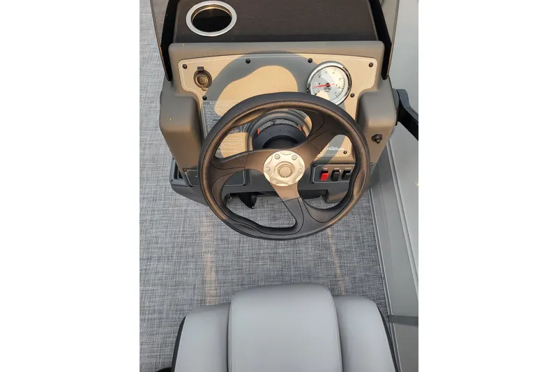 Slide: The Image of Steering console of 2026 Sun Tracker Party Barge 16 DLX with gauges and controls. - 10