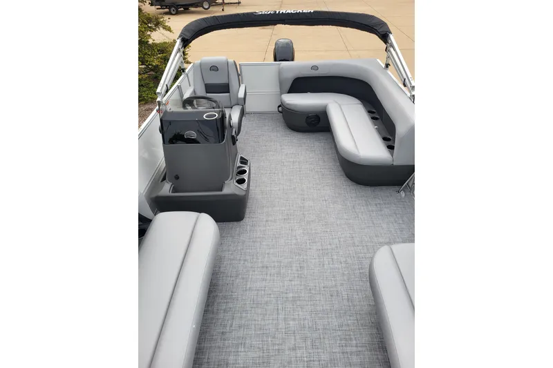 Slide: The Image of 2026 Sun Tracker Party Barge 16 DLX interior with gray seating and carpeted floor. - 2