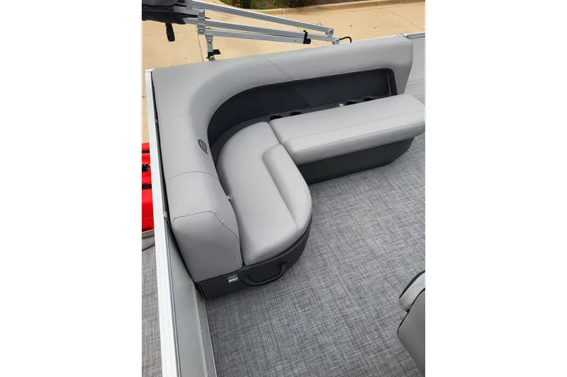 Slide: The Image of 2026 Sun Tracker Party Barge 16 DLX with gray cushioned seating and carpeted floor. - 4