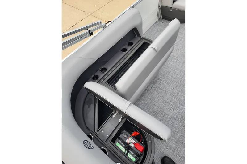 Slide: The Image of 2026 Sun Tracker Party Barge 16 DLX interior with storage compartment and cup holders. - 5