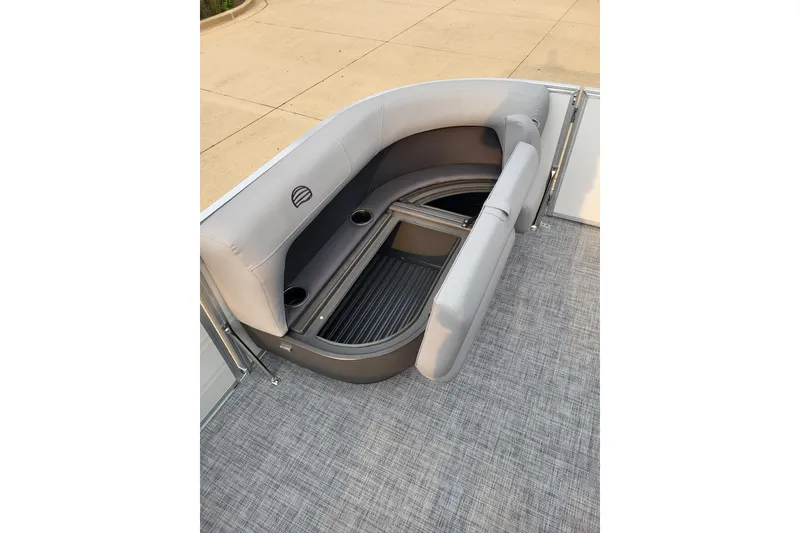 Slide: The Image of 2026 Sun Tracker Party Barge 16 DLX interior seating with storage and cup holders. - 7