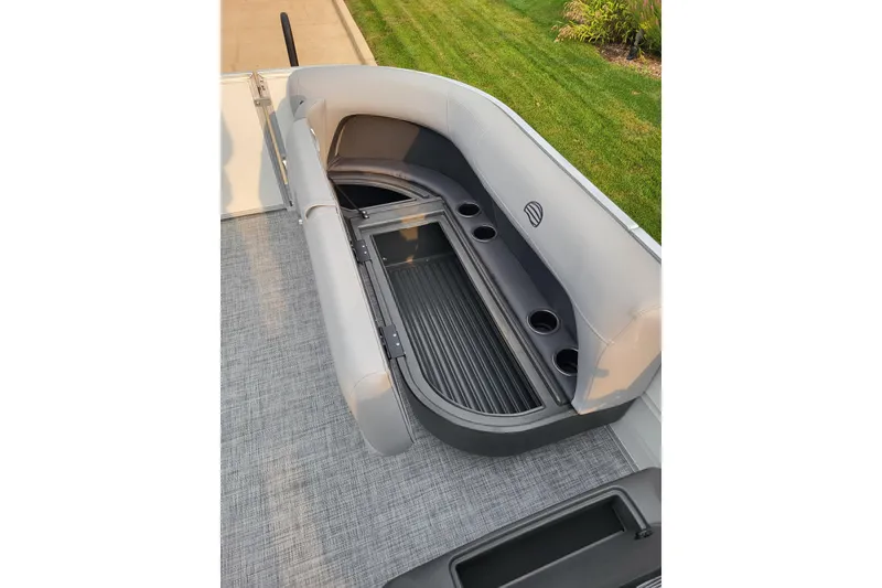 Slide: The Image of 2026 Sun Tracker Party Barge 16 DLX with open storage compartment and cup holders. - 9
