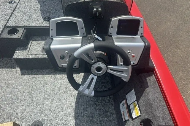 Slide: The Image of 2026 Tracker Pro Team 175 boat dashboard with dual displays and steering wheel. - 16