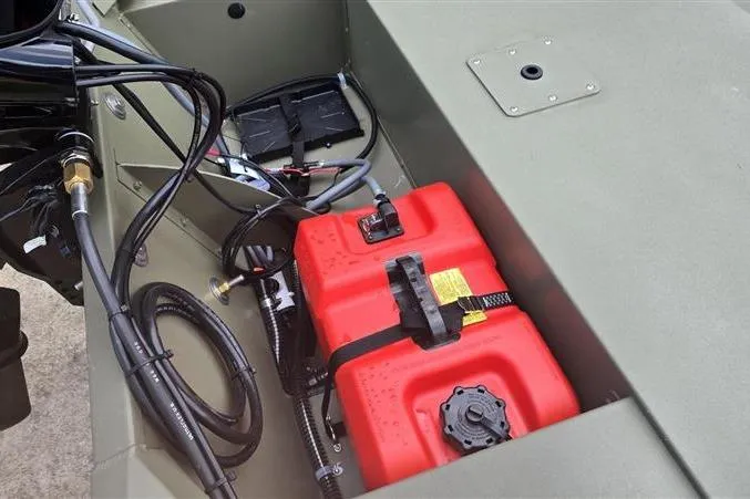 Slide: The Image of 2026 Tracker Grizzly 1648 SC boat interior with red fuel tank and wiring. - 9