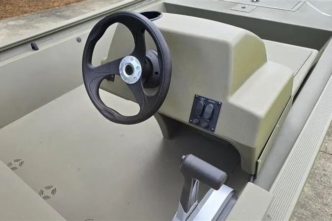 Slide: The Image of 2026 Tracker Grizzly 1648 SC boat interior with steering wheel and control panel. - 8