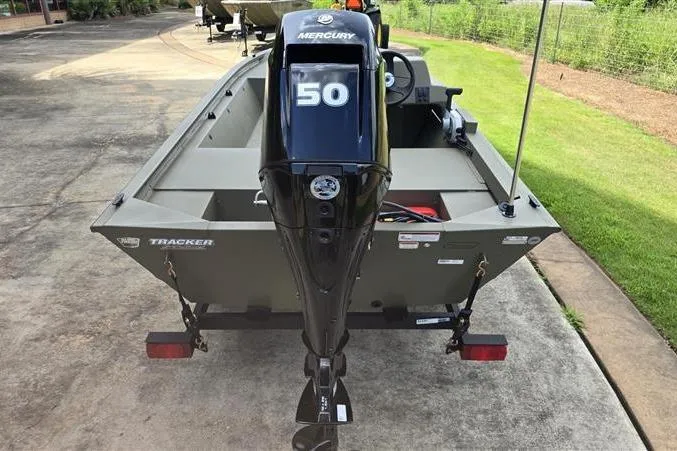 Slide: The Image of 2026 Tracker Grizzly 1648 SC boat with Mercury 50 engine, parked on concrete. - 7