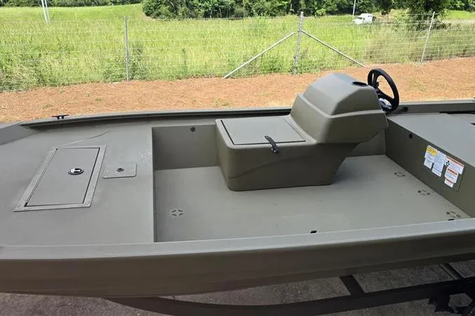 Slide: The Image of 2026 Tracker Grizzly 1648 SC boat interior with steering console and storage compartments. - 4