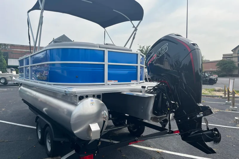Slide: The Image of 2026 Sun Tracker Party Barge 20 DLX pontoon boat with outboard motor in parking lot. - 4