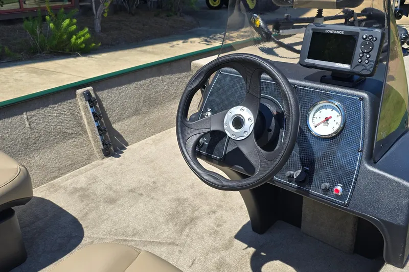 Slide: The Image of 2026 Tracker Bass Tracker Classic Limited boat dashboard with steering wheel and navigation system. - 4