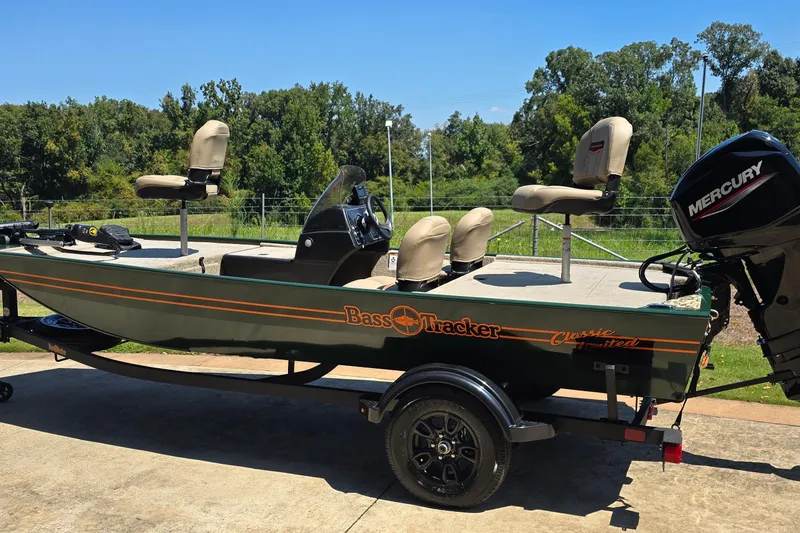 Slide: The Image of 2026 Tracker Bass Tracker Classic Limited boat with Mercury engine on trailer. - 2