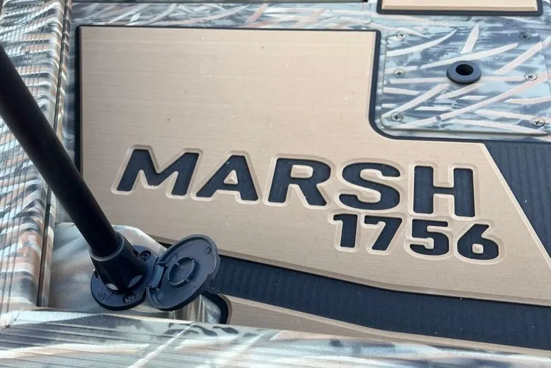 Slide: The Image of 2026 Tracker Grizzly 1756 T Marsh boat detail with camouflage design. - 2
