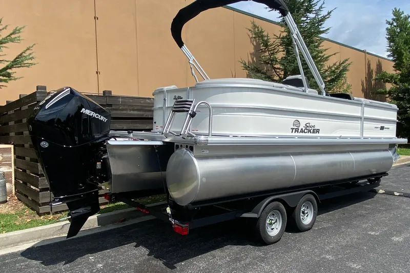 Slide: The Image of 2026 Sun Tracker Party Barge 22 XP3 pontoon boat with Mercury outboard engine on trailer. - 1