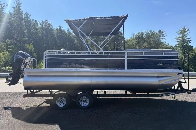 Slide: The Image of 2026 Sun Tracker SportFish 20 DLX pontoon boat on trailer, parked outdoors. - 3