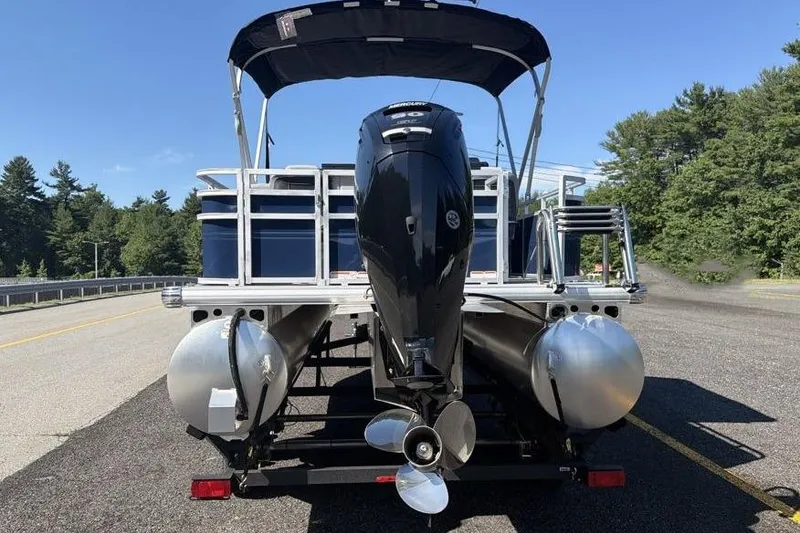 Slide: The Image of 2026 Sun Tracker SportFish 20 DLX pontoon boat with outboard motor on a sunny day. - 7