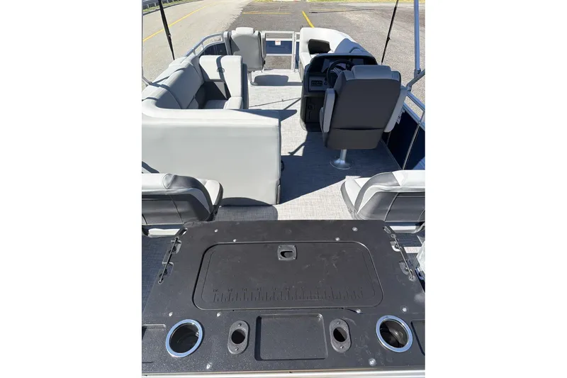 Slide: The Image of 2026 Sun Tracker SportFish 20 DLX pontoon boat interior with seating and helm. - 10