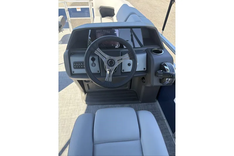 Slide: The Image of 2026 Sun Tracker SportFish 20 DLX boat dashboard with steering wheel and controls. - 9