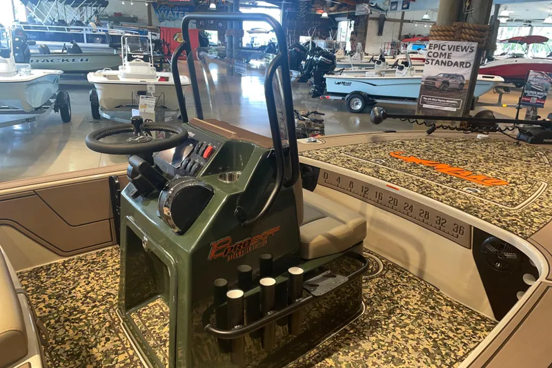 Slide: The Image of 2026 Mako 18 Pro Skiff Backwater Edition boat interior with camouflage design and steering console. - 2