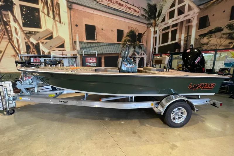 The Image of A 2026 Mako 18 Pro Skiff Backwater Edition on a trailer in a showroom setting. - 0