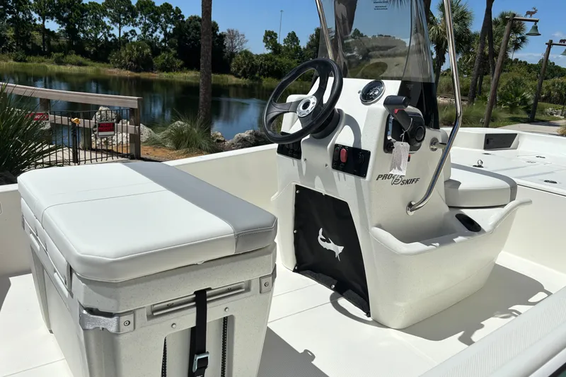 Slide: The Image of 2026 Mako Pro Skiff 15 CC boat interior with steering console and seating. - 13