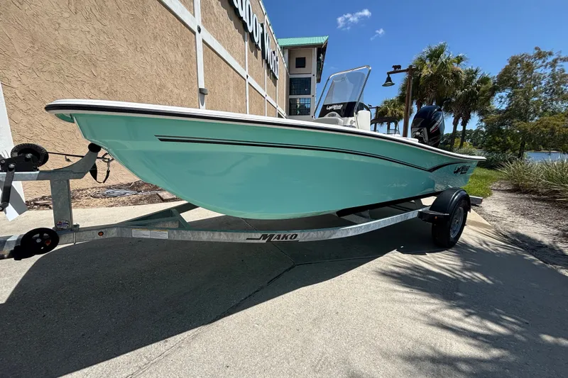 Slide: The Image of 2026 Mako Pro Skiff 15 CC boat on trailer, parked outdoors under clear sky. - 7