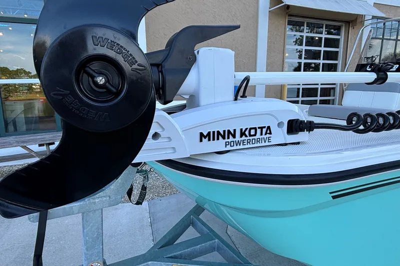 Slide: The Image of 2026 Mako Pro Skiff 15 CC with Minn Kota PowerDrive motor on trailer. - 7