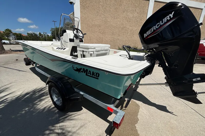 Slide: The Image of 2026 Mako Pro Skiff 15 CC boat with Mercury engine on trailer. - 5