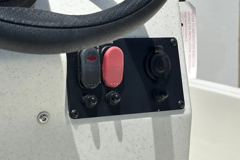 Slide: The Image of Control panel of 2026 Mako Pro Skiff 15 CC boat with switches and 12V outlet. - 10
