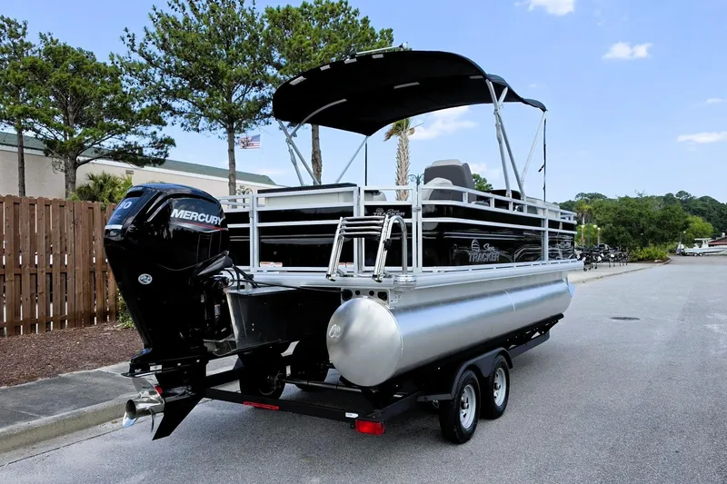 Slide: The Image of 2026 Sun Tracker Fishin' Barge 20 DLX pontoon boat with Mercury engine on trailer. - 3