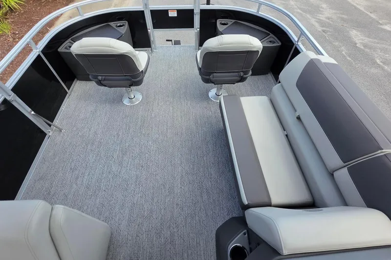 Slide: The Image of 2026 Sun Tracker Fishin' Barge 20 DLX interior with seating and carpeted flooring. - 17