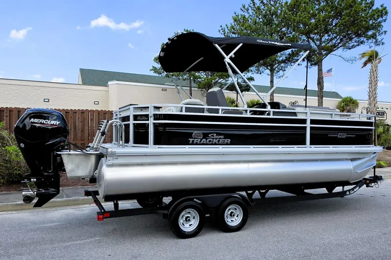 The Image of 2026 Sun Tracker Fishin' Barge 20 DLX pontoon boat with Mercury engine on trailer. - 0