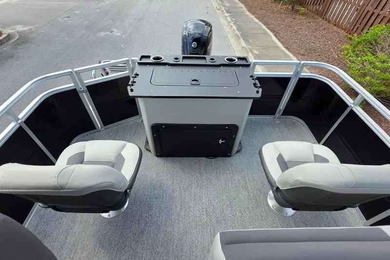 Slide: The Image of 2026 Sun Tracker Fishin' Barge 20 DLX interior with seating and control console. - 15