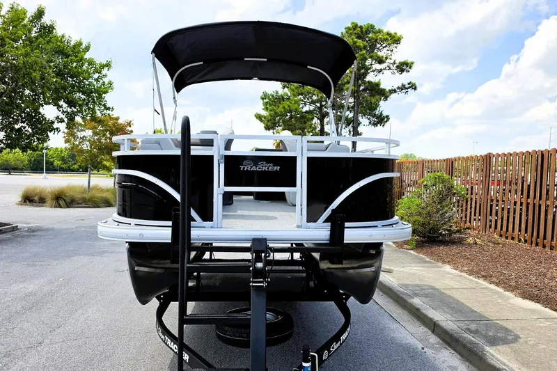 Slide: The Image of 2026 Sun Tracker Fishin' Barge 20 DLX pontoon boat in parking lot. - 11