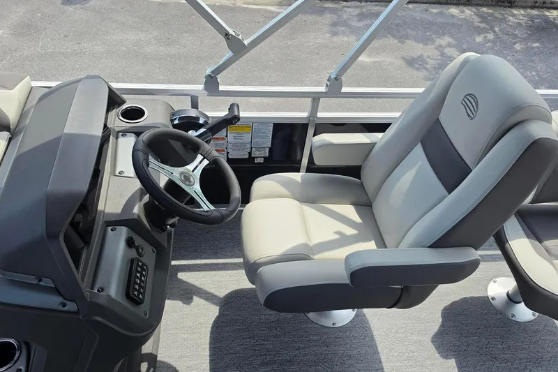 Slide: The Image of Captain's seat and helm of 2026 Sun Tracker Fishin' Barge 20 DLX pontoon boat. - 13