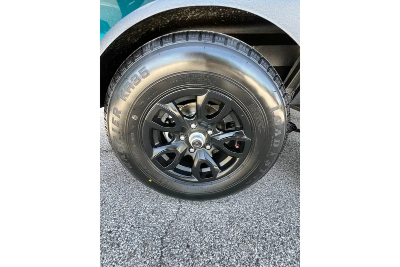 Slide: The Image of Close-up of a 2026 Tahoe 1950 wheel with black alloy rim and tire. - 9