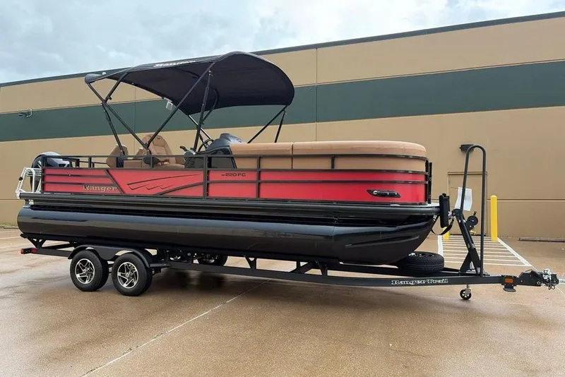 Slide: The Image of 2026 Ranger 220FC pontoon boat on trailer, featuring a red and black design. - 3