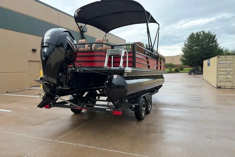 Slide: The Image of 2026 Ranger 220FC pontoon boat with Mercury engine on trailer in parking lot. - 2