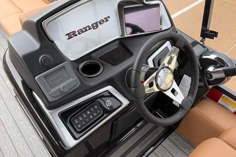 Slide: The Image of 2026 Ranger 220FC boat dashboard with steering wheel, control panel, and touchscreen display. - 8