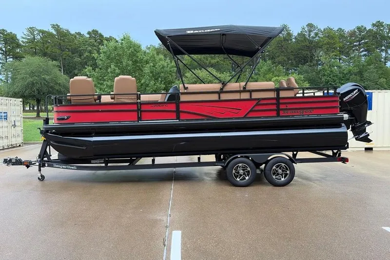 The Image of 2026 Ranger 220FC pontoon boat with red and black design on a trailer. - 0