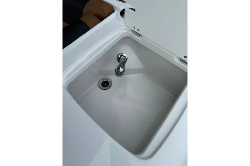 Slide: The Image of 2026 Tahoe 2150 boat sink with faucet, featuring sleek white design and modern functionality. - 15
