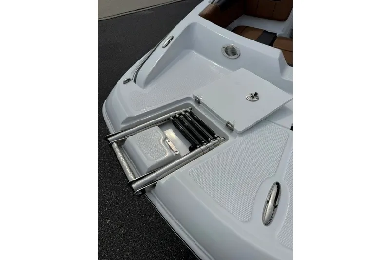 Slide: The Image of 2026 Tahoe 2150 boat with a foldable ladder and storage compartment. - 19