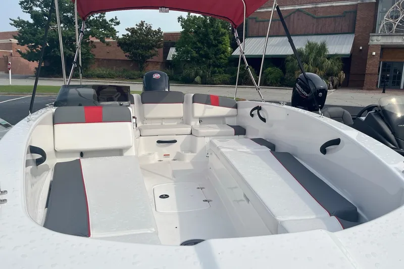 Slide: The Image of 2026 Tahoe T18 boat with spacious seating and modern design, parked outdoors. - 7