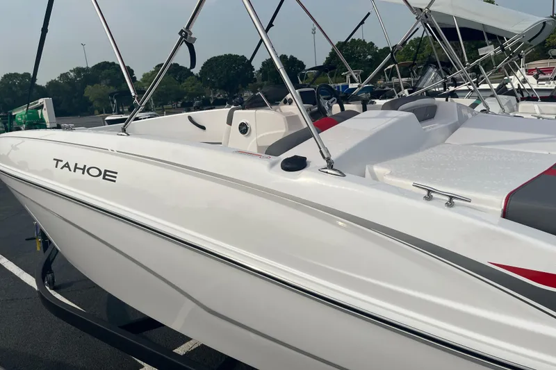 Slide: The Image of 2026 Tahoe T18 boat with sleek white design and modern features, parked outdoors. - 3