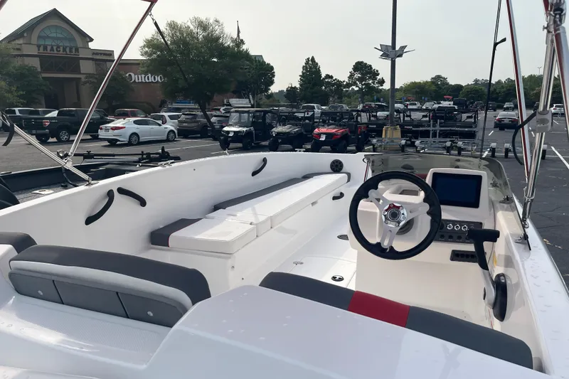Slide: The Image of 2026 Tahoe T18 boat interior with steering wheel and seating, parked outdoors. - 6