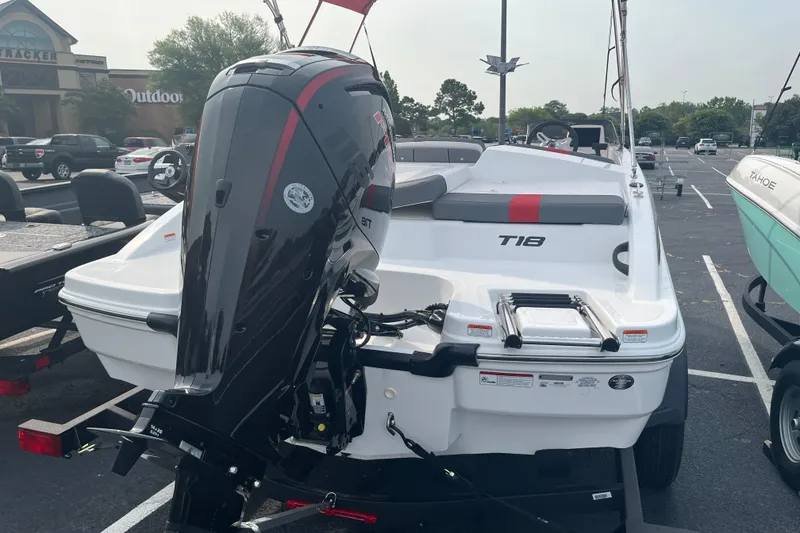 Slide: The Image of 2026 Tahoe T18 boat with outboard motor in a parking lot. - 5